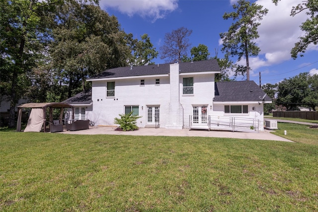 rear view of house with a patio, a gazebo, french doors, and a yard