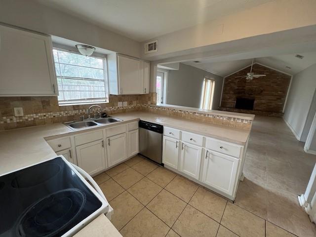 kitchen featuring white cabinetry, dishwasher, sink, and kitchen peninsula