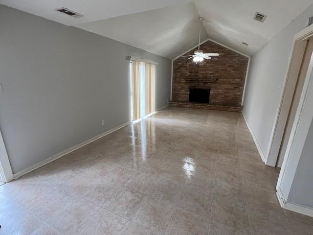 unfurnished living room with lofted ceiling, a fireplace, and ceiling fan