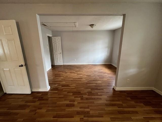 unfurnished room featuring dark wood-type flooring