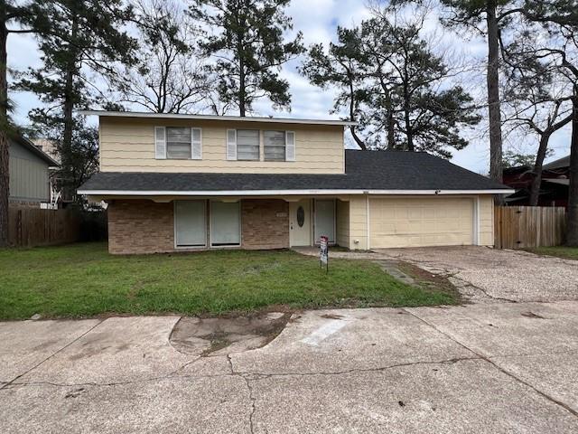 view of property with a garage and a front yard