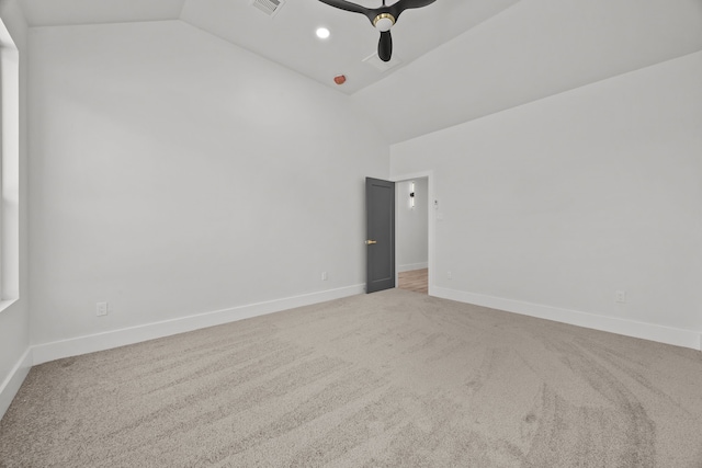 carpeted empty room featuring ceiling fan and vaulted ceiling