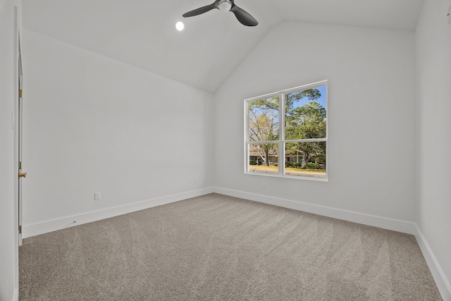 spare room with lofted ceiling, carpet floors, and ceiling fan