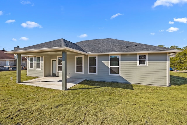 rear view of house with a yard and a patio