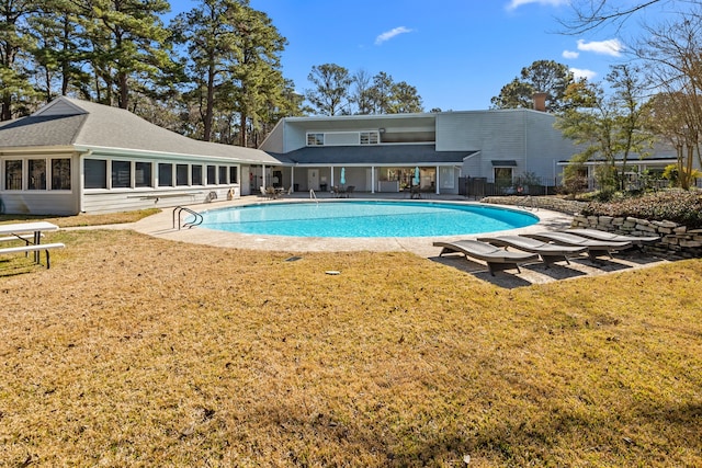 view of swimming pool featuring a lawn and a patio