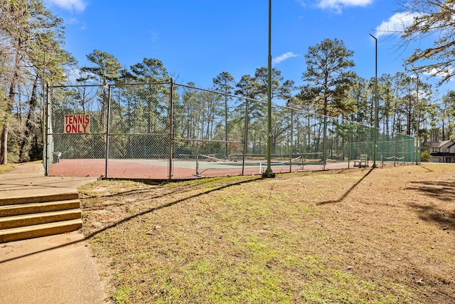 view of community featuring tennis court