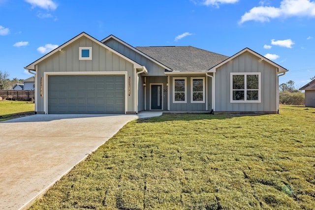 single story home featuring a garage and a front lawn