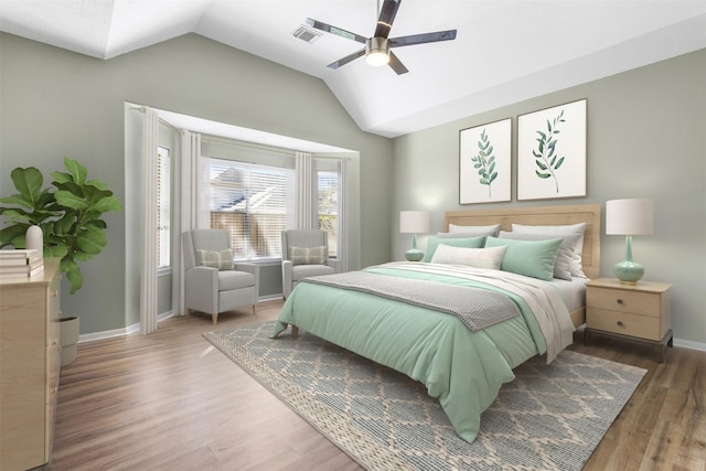 bedroom with lofted ceiling, dark hardwood / wood-style floors, and ceiling fan