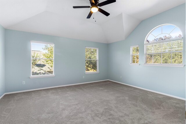 carpeted spare room featuring lofted ceiling and ceiling fan