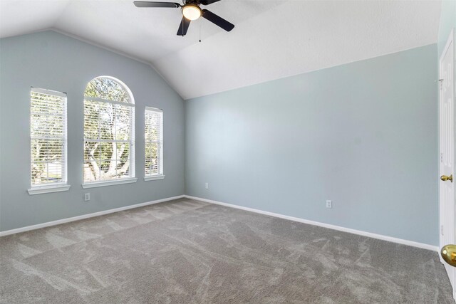 empty room featuring vaulted ceiling, ceiling fan, and carpet