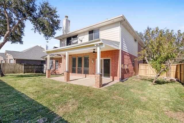 back of house featuring a lawn, a patio, and ceiling fan