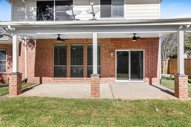 rear view of property featuring a yard, a patio, and ceiling fan