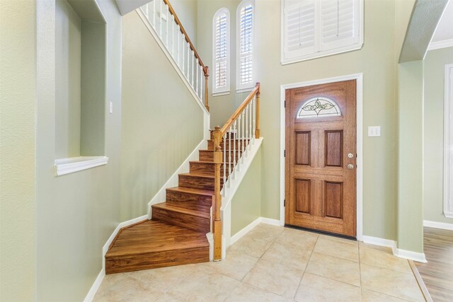 tiled foyer entrance featuring a high ceiling