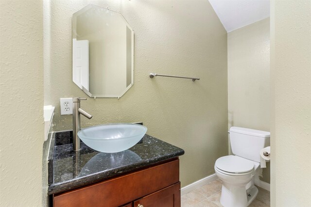 bathroom with vanity, tile patterned floors, and toilet