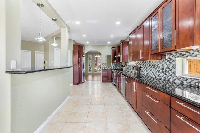 kitchen with light tile patterned floors, dishwasher, pendant lighting, dark stone counters, and decorative backsplash