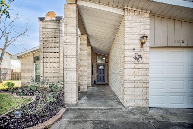 view of exterior entry with a garage