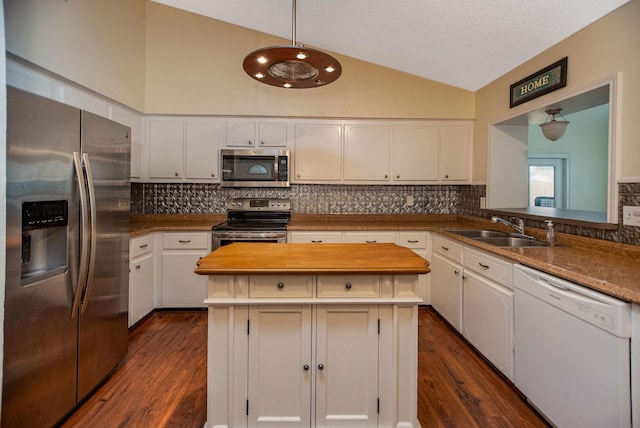 kitchen featuring white cabinetry, appliances with stainless steel finishes, a center island, and sink