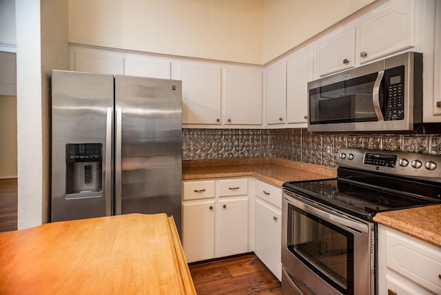 kitchen featuring tasteful backsplash, dark wood-type flooring, stainless steel appliances, and white cabinets