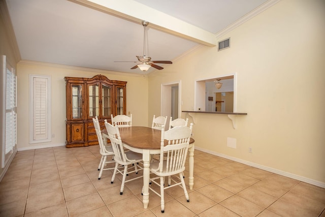 tiled dining area featuring ornamental molding, vaulted ceiling with beams, and ceiling fan