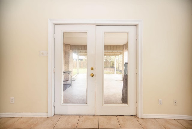 doorway to outside featuring french doors and light tile patterned floors