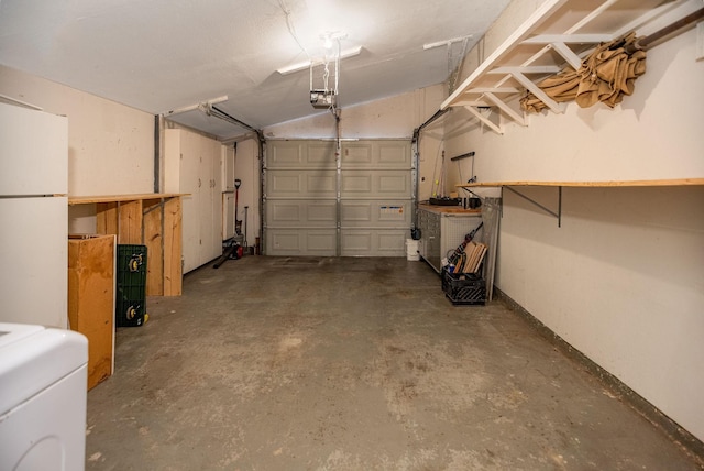 garage featuring white refrigerator, washer / dryer, and a garage door opener