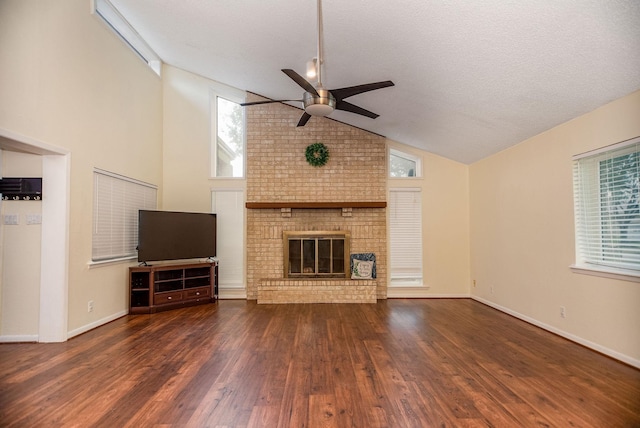 unfurnished living room with a fireplace, a textured ceiling, dark wood-type flooring, and ceiling fan