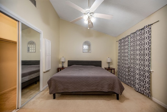 bedroom featuring ceiling fan, lofted ceiling, and light carpet