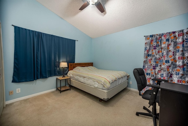 bedroom with lofted ceiling, light carpet, a textured ceiling, and ceiling fan