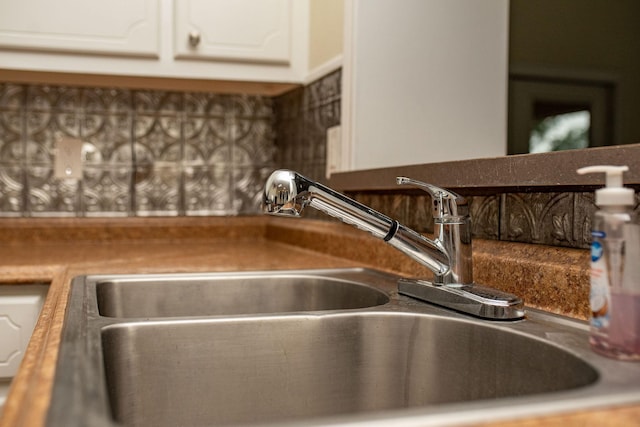 details featuring white cabinetry and sink