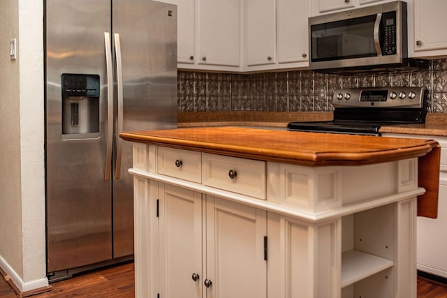 kitchen featuring stainless steel appliances, white cabinetry, and dark hardwood / wood-style floors