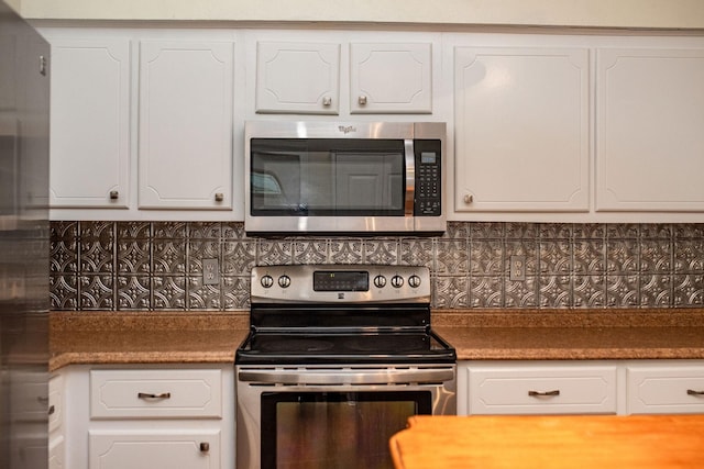 kitchen featuring stainless steel appliances and white cabinets