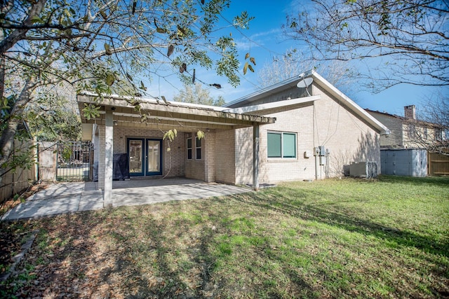 rear view of house featuring central AC, a yard, and a patio area