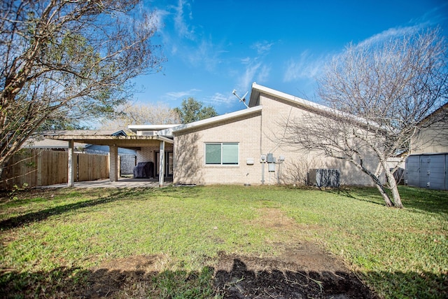 rear view of property with a patio and a yard