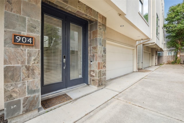 doorway to property featuring a garage and french doors