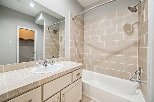 bathroom featuring vanity and tiled shower / bath combo