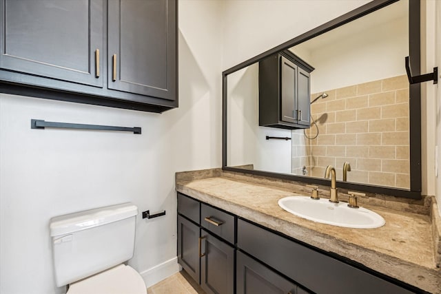 bathroom featuring tile patterned flooring, vanity, backsplash, and toilet