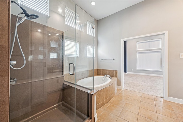 bathroom with separate shower and tub and tile patterned flooring