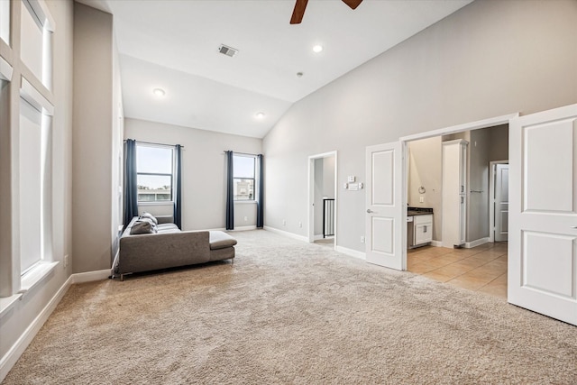 unfurnished room featuring ceiling fan, high vaulted ceiling, and light carpet