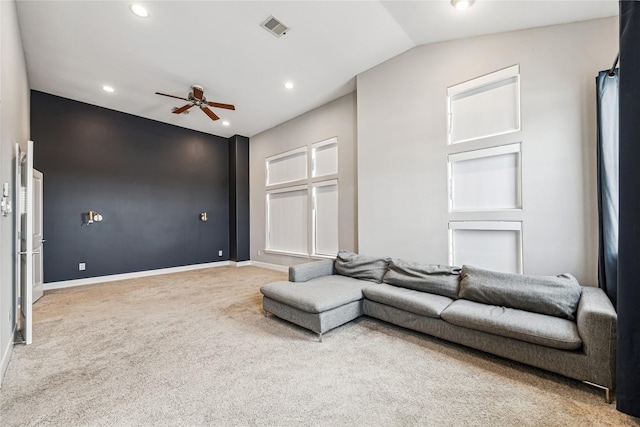 carpeted living room featuring vaulted ceiling and ceiling fan