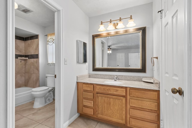 full bathroom with tiled shower / bath combo, vanity, toilet, tile patterned floors, and a textured ceiling