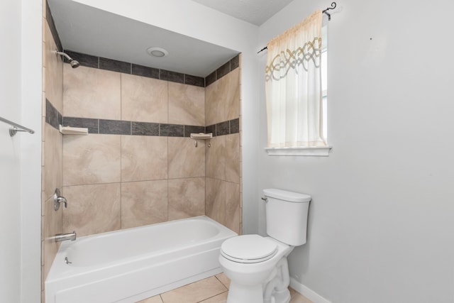 bathroom featuring tile patterned floors, toilet, and tiled shower / bath