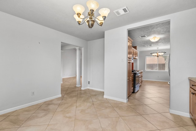 unfurnished dining area with light tile patterned floors, a notable chandelier, and a textured ceiling