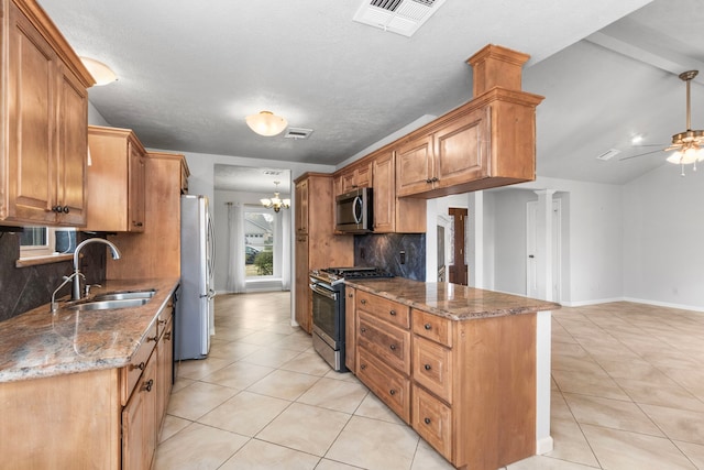 kitchen featuring ceiling fan with notable chandelier, sink, dark stone countertops, light tile patterned floors, and stainless steel appliances