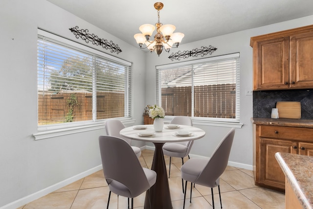 tiled dining area featuring an inviting chandelier