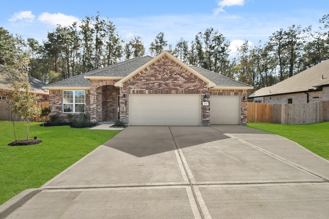 view of front of house featuring a garage and a front lawn