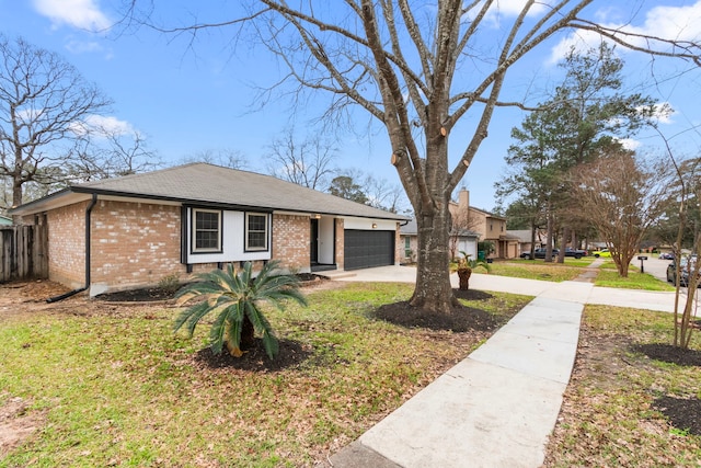 view of front of property with a front lawn, concrete driveway, brick siding, and an attached garage