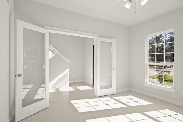 unfurnished bedroom with ceiling fan and french doors