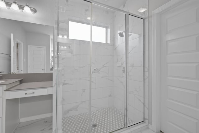 bathroom featuring a shower with door and vanity