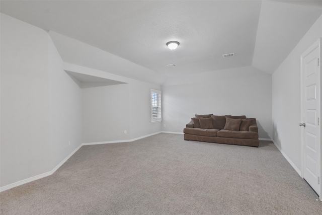 sitting room with lofted ceiling and carpet floors