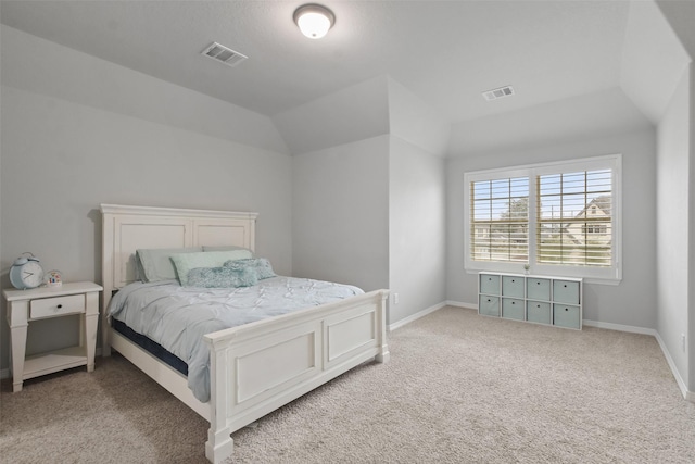 carpeted bedroom with lofted ceiling